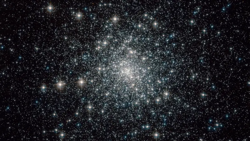 A densely packed ball of stars, thickest at the middle, against a black background.