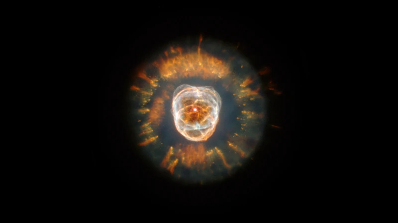 A round nebula with a bright, layered core and a ring of orange gas streamers around it, against a black sky.